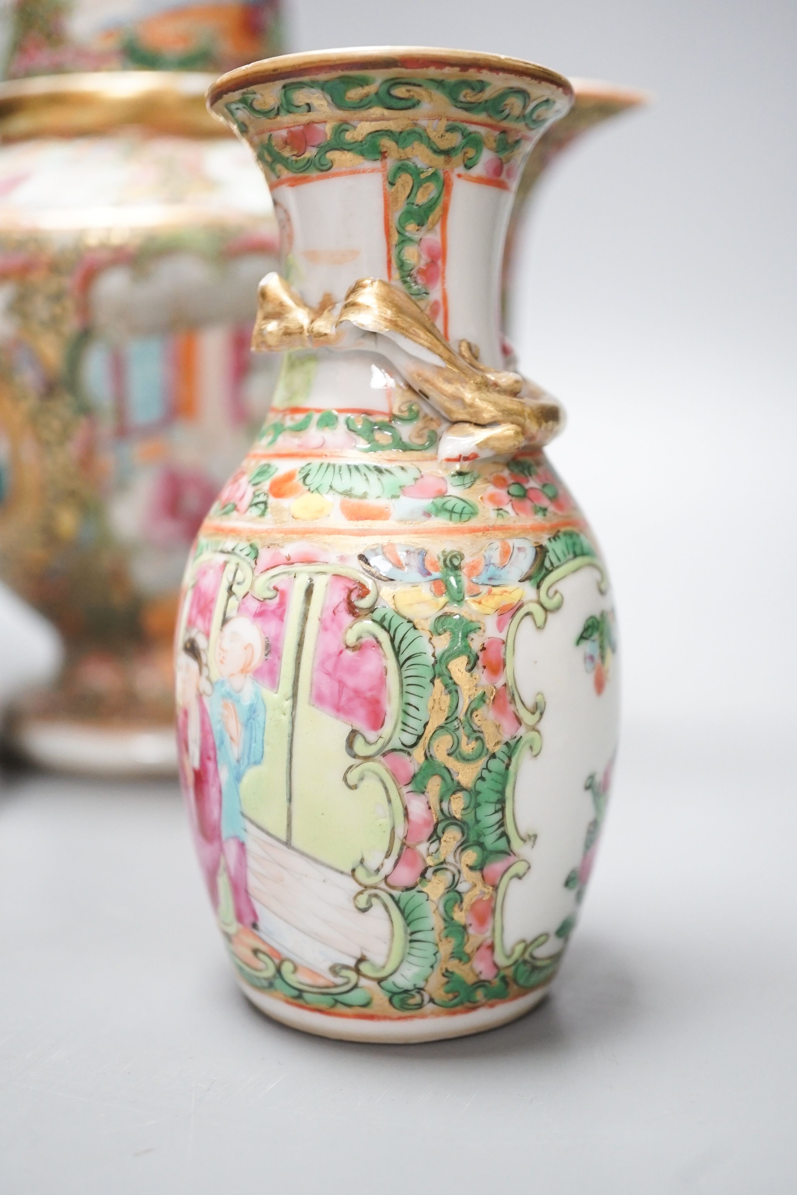 A 19th century Chinese famille rose teapot, sugar bowl, saucer dish vase and a similar yellow ground ‘dragon’ vase and cover 21cm